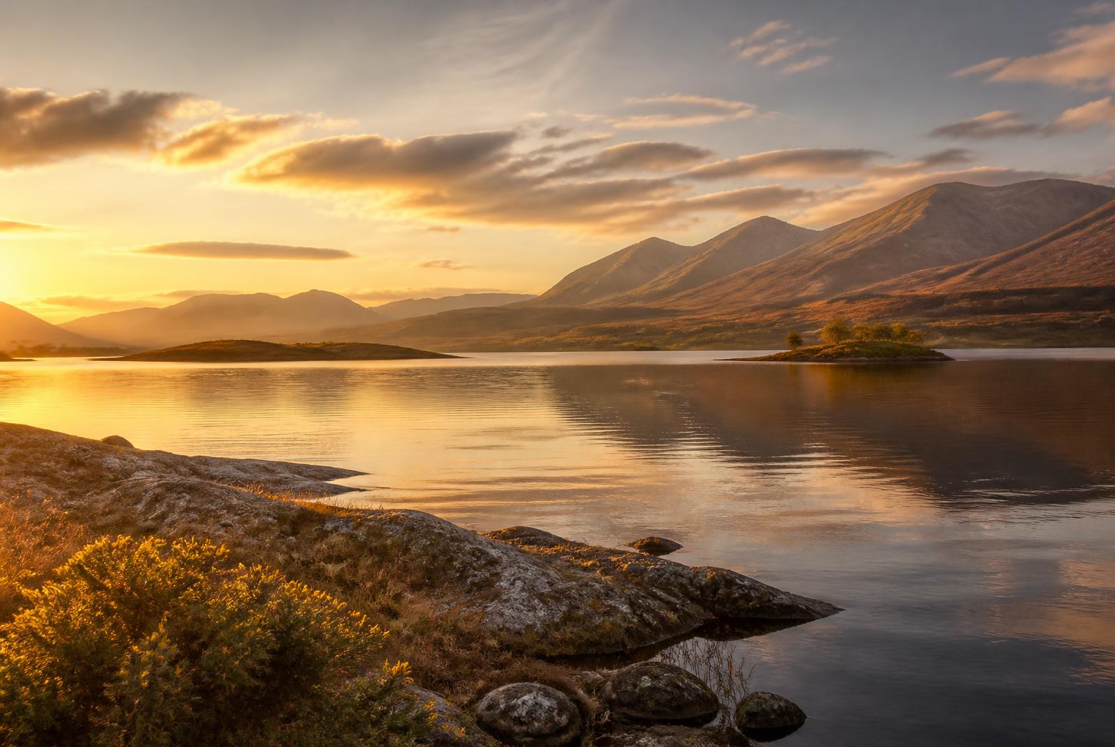 Golden light over a calm Scottish loch